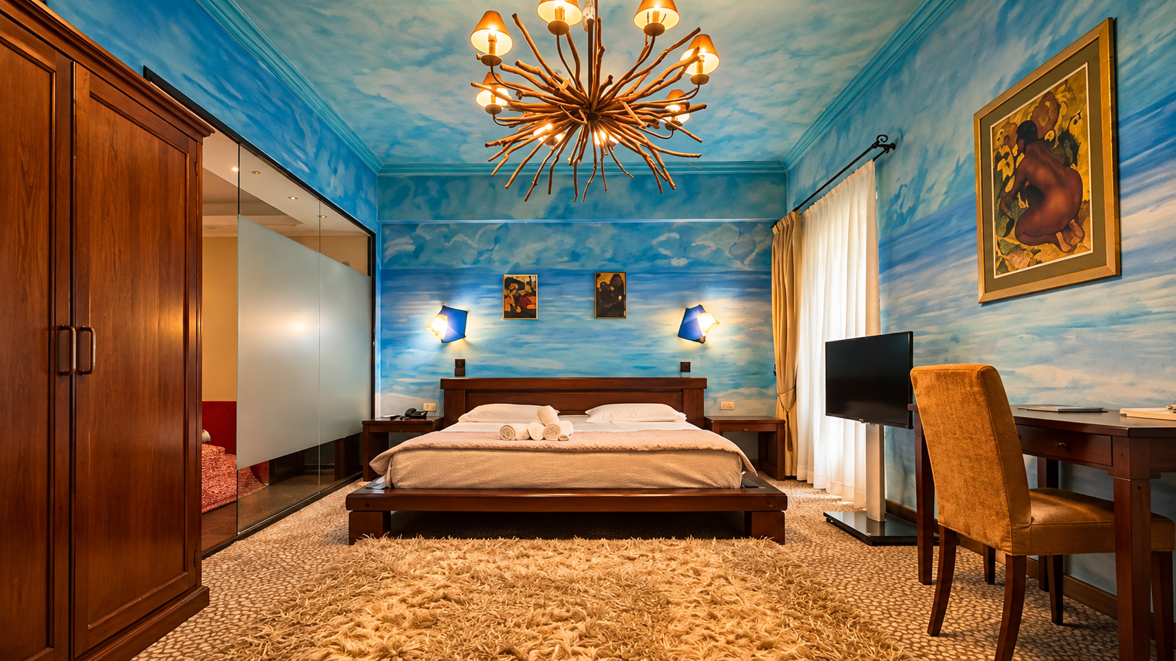 Standard Double Room with blue sky painted walls, rustic wooden bed, and branch chandelier at Anastazia Luxury Suites & Spa