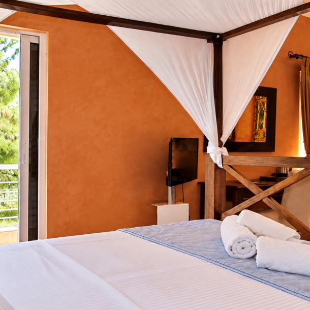 Luxury Family Suite balcony view and canopy bed at Anastazia Luxury Suites & Spa