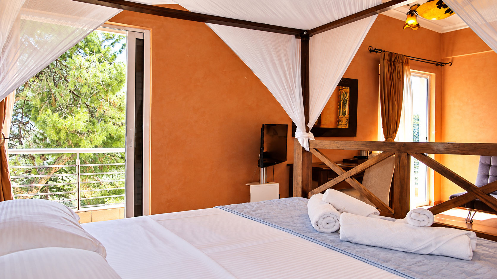 Luxury Family Suite balcony view and canopy bed at Anastazia Luxury Suites & Spa