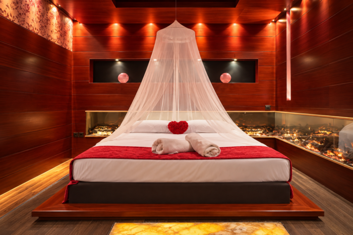 Romantic suite bedroom with wooden walls and a canopy bed at Anastazia Luxury Suites & Spa