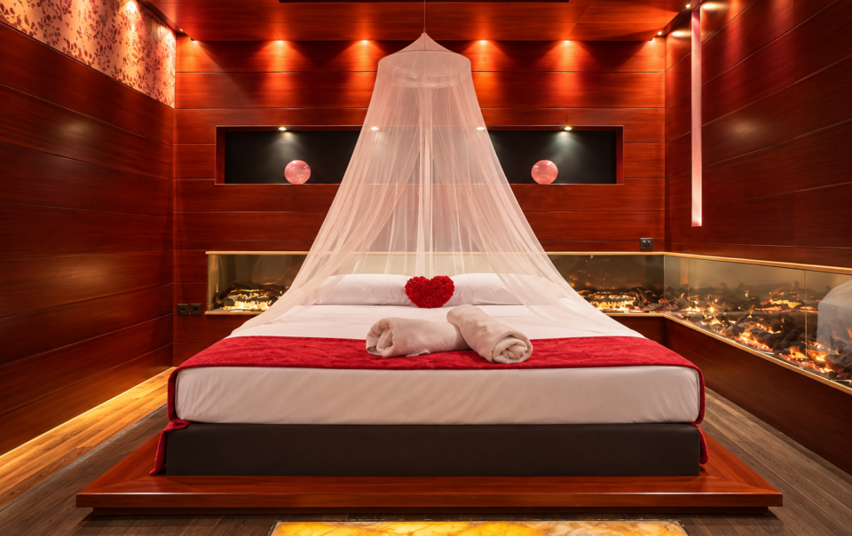 Romantic suite bedroom with wooden walls and a canopy bed at Anastazia Luxury Suites & Spa